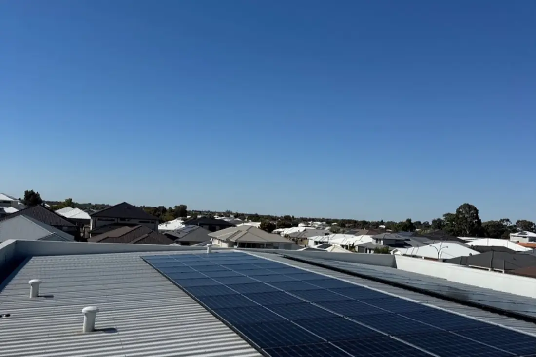 Commercial rooftop solar array overlooking surrounding rooftops