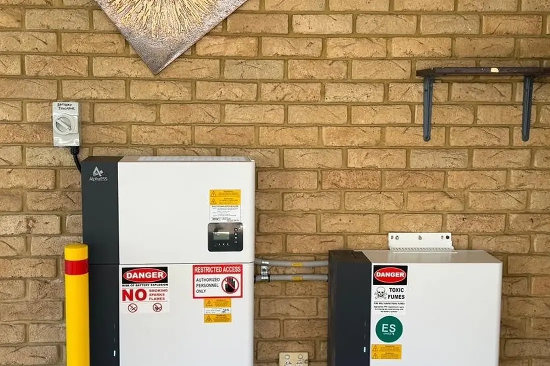 Two battery units installed side by side on a brick wall