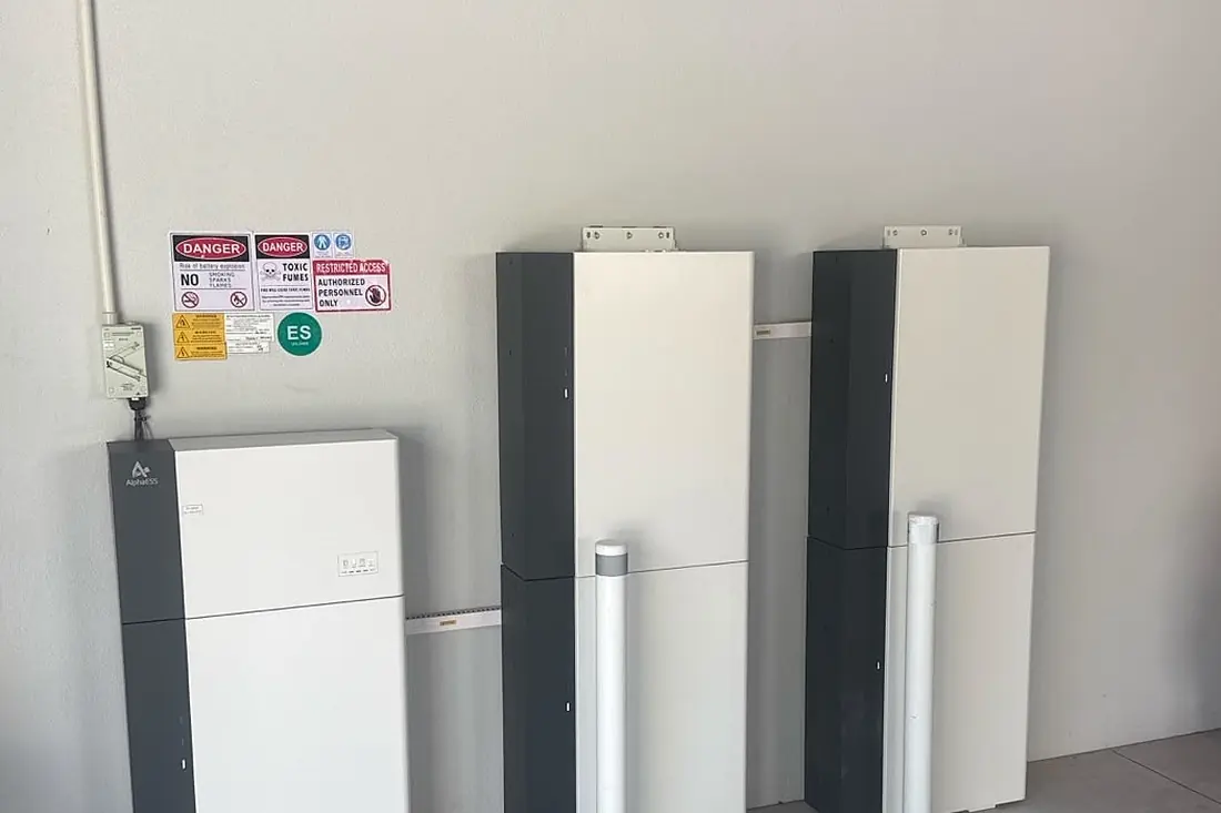 Three battery units installed side by side in a Perth garage