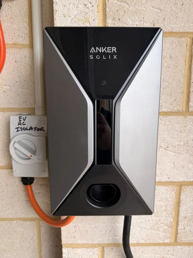 Anker SOLIX EV charger mounted on a brick wall